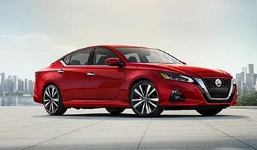2023 Nissan Altima in red with city in background illustrating last year's 2022 model in Ed Martin Nissan in Indianapolis IN