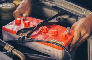 A mechanic changing a car's battery near Indianapolis, Indiana