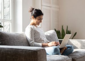 A person shopping for a car online from their home near Fishers, Indiana