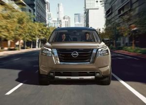  A front view of a 2024 Nissan Pathfinder, driving down a city road near Indianapolis, Indiana