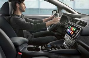 A person driving their 2024 Nissan LEAF, photographed from the interior passenger seat side near Indianapolis, Indiana
