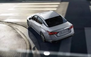 A silver 2024 Nissan Altima driving out of a parking garage near Indianapolis, Indiana