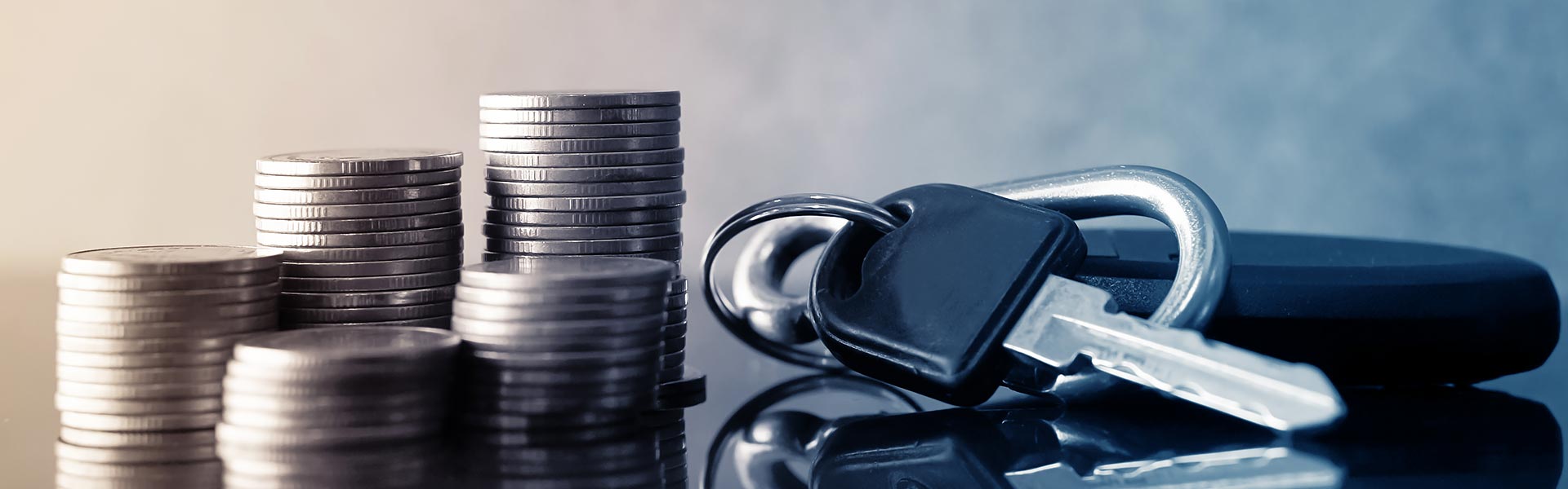Car keys beside money stacks