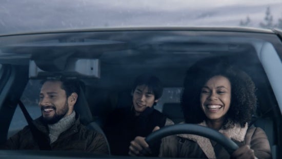 Three passengers riding in a vehicle and smiling | Ed Martin Nissan in Indianapolis IN