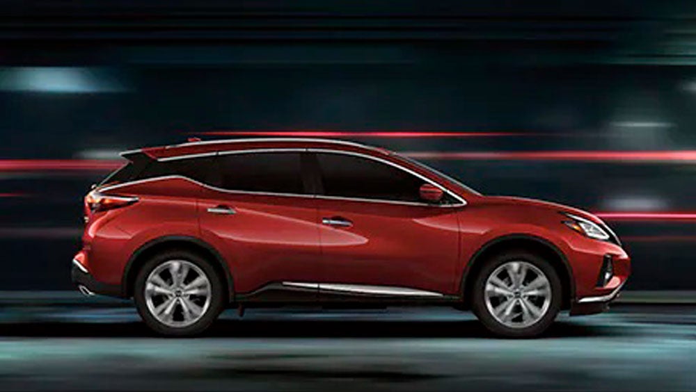 2023 Nissan Murano shown in profile driving down a street at night illustrating performance. | Ed Martin Nissan in Indianapolis IN