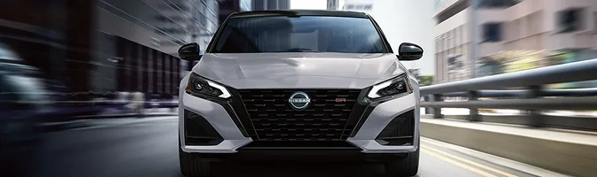 Front view of a gray Nissan Altima on a city street