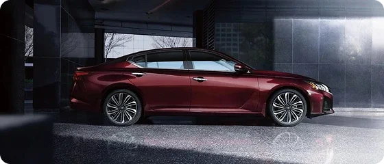 2026 Nissan Altima SV in dark red parked inside a modern building, side view