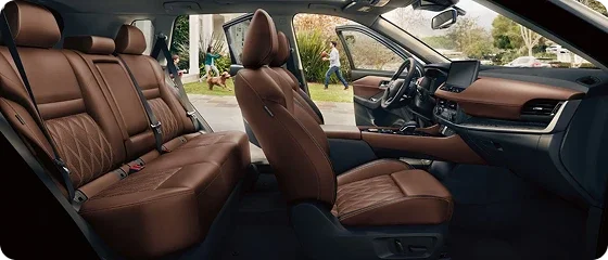 Interior of the 2026 Nissan Rogue Platinum AWD showing both rows of quilted brown semi-aniline leather-appointed seats