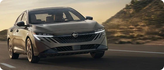 2026 Nissan Sentra SV driving on a highway at sunset, front view