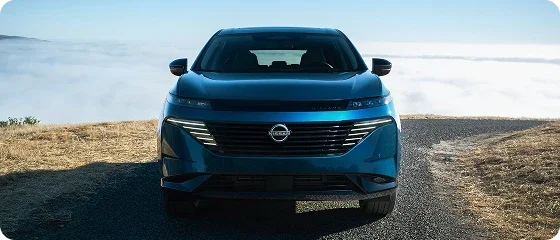 2026 Nissan Murano Platinum AWD in blue parked on a ridge above the clouds, head-on view