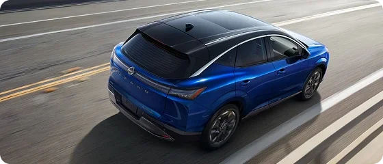 Overhead view of the 2026 Nissan Murano Platinum AWD in blue driving on a wet road, showing its panoramic moonroof