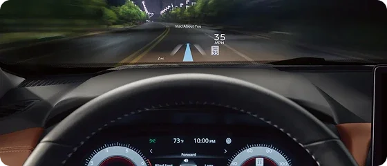 Head-up display projected on the windshield of the 2026 Nissan Rogue Platinum AWD showing speed and navigation guidance at night