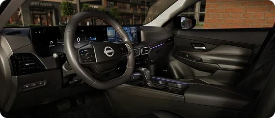 Driver's side interior of the 2026 Nissan Sentra SV showing the steering wheel, dual 12.3-inch displays and center console