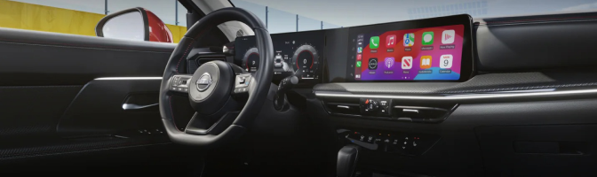Nissan dashboard with the steering wheel, driver display and wide center touchscreen