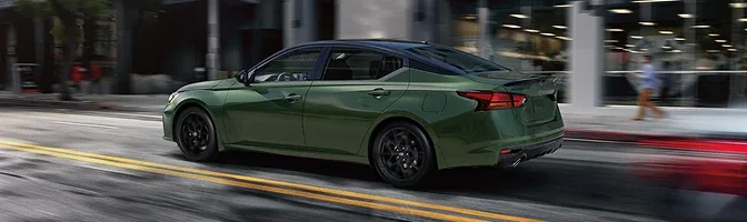 Green 2026 Nissan Altima moving through city traffic