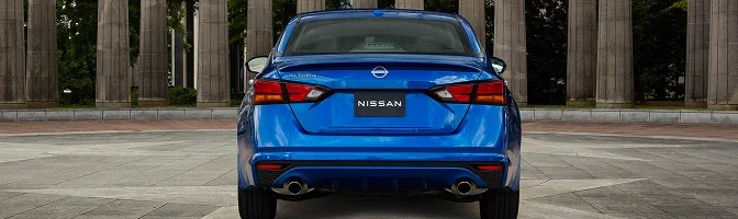 Rear view of a blue 2026 Nissan Altima showing the Nissan badge and twin exhaust outlets