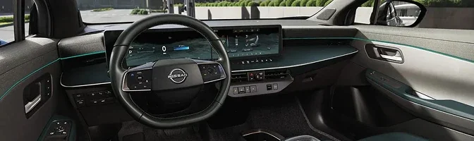 Dashboard of the 2026 Nissan LEAF showing the steering wheel and twin display screens