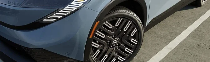 Close-up of the front wheel and alloy on a grey-blue 2026 Nissan LEAF