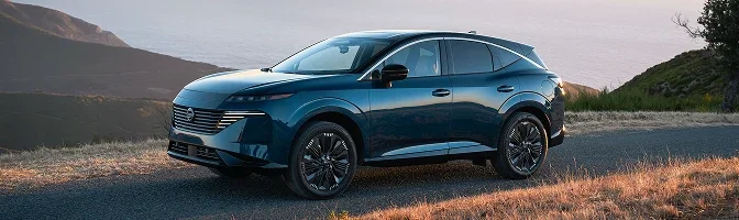 Dark teal 2026 Nissan Murano parked on a coastal ridge at dusk