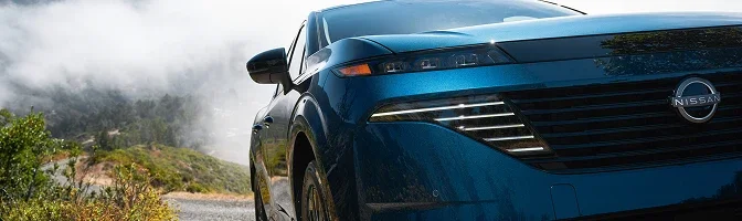Close-up of the front grille and headlight on a blue 2026 Nissan Murano