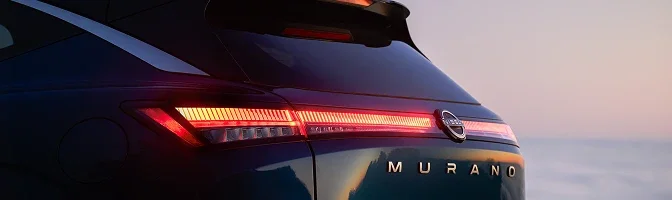 Close-up of the rear light bar and MURANO badge on a dark blue Murano at dusk