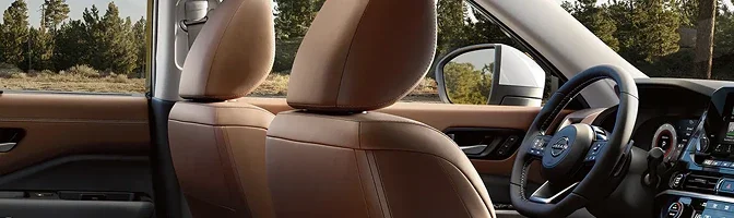 Front seats of the 2026 Nissan Pathfinder in tan leather with the steering wheel beyond