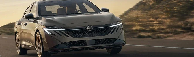 Front three-quarter view of a bronze 2026 Nissan Sentra on a desert road