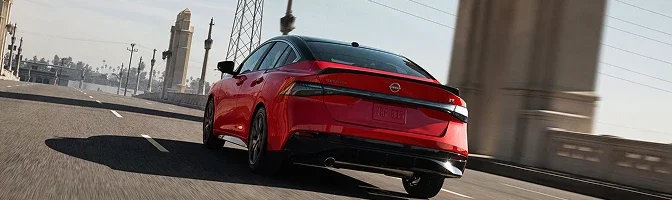 Rear view of a red 2026 Nissan Sentra crossing a bridge